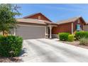 Single-story home featuring a 2-car garage, neutral color palette and tidy landscape in front at 652 E Rojo Way, Gilbert, AZ 85297