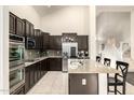 Bright kitchen with stainless steel appliances and a breakfast bar at 6971 W El Cortez Pl, Peoria, AZ 85383