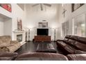 Spacious living room features a fireplace, dark hardwood floors, and vaulted ceilings at 6971 W El Cortez Pl, Peoria, AZ 85383