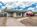 Single-story home featuring a carport, covered entry, xeriscaping and a comfortable desert setting at 738 S Pomeroy --, Mesa, AZ 85210