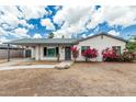 Charming single-story home with a covered carport, flowering bushes and a sidewalk leading to the front entry at 738 S Pomeroy --, Mesa, AZ 85210