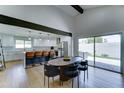 Open dining area next to a gourmet kitchen, with modern table and chairs and sliding door access to the backyard at 7524 N Via Del Elemental --, Scottsdale, AZ 85258