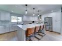 Bright, modern kitchen featuring a large island with seating, stainless steel appliances, and custom cabinetry at 7524 N Via Del Elemental --, Scottsdale, AZ 85258