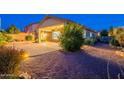The backyard features an expansive covered patio with pavers and desert-friendly landscaping at 7606 E Globemallow Ln, Gold Canyon, AZ 85118
