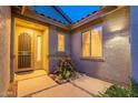 Inviting front entrance with a security door, stylish lighting, and desert landscaping at 7606 E Globemallow Ln, Gold Canyon, AZ 85118
