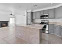 Open concept kitchen featuring gray cabinetry, an island, and stainless steel appliances at 7767 W Sierra Vista Dr, Glendale, AZ 85303
