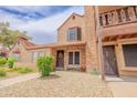 Charming townhome featuring a brick chimney, cozy balcony, and well-maintained landscaping at 8111 W Wacker Rd # 62, Peoria, AZ 85381