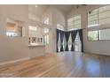 Bright and open living room featuring high ceilings, hardwood floors, and large windows at 8502 E Santa Catalina Dr, Scottsdale, AZ 85255