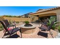 Outdoor fire pit area with seating, ideal for relaxing and enjoying the backyard landscape at 8544 E Kael St, Mesa, AZ 85207