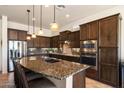 Gourmet kitchen with granite countertops, stainless steel appliances, and ample cabinet space at 8544 E Kael St, Mesa, AZ 85207