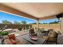 Inviting covered patio with comfortable seating, perfect for outdoor dining and entertaining at 8544 E Kael St, Mesa, AZ 85207