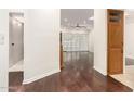 Open living room featuring hardwood floors and a built-in cabinet near the doorway at 902 W Glendale Ave # 102, Phoenix, AZ 85021