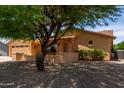 Charming single-story home with desert landscaping and mature shade tree in front yard at 922 S 80Th St, Mesa, AZ 85208