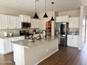 Bright kitchen with granite countertops, an island with a sink, stainless steel appliances, and a pantry at 984 W Belmont Red Trl, San Tan Valley, AZ 85143