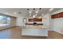 Open concept kitchen featuring a large center island with granite countertops, stainless steel appliances, and modern pendant lighting at 984 W Belmont Red Trl, San Tan Valley, AZ 85143