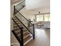 View of the living room showing the staircase, high ceilings, and large windows at 984 W Belmont Red Trl, San Tan Valley, AZ 85143