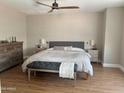 Serene main bedroom featuring a king bed, neutral tones, and hardwood floors for a cozy and relaxing atmosphere at 984 W Belmont Red Trl, San Tan Valley, AZ 85143