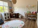 Bright ' room features hardwood floors, maps, and play furniture, creating an engaging and inspiring learning environment at 984 W Belmont Red Trl, San Tan Valley, AZ 85143