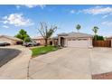 A cozy single-story home with a two-car garage, desert landscaping, and a spacious driveway at 10280 N 94Th Dr, Peoria, AZ 85345