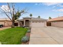 Inviting single-story house features a desert-landscaped front yard and a convenient two-car garage at 10280 N 94Th Dr, Peoria, AZ 85345
