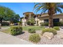 Charming home with mature palm trees, lush green lawn, and meticulous rock landscaping at 10434 N 44Th N St, Phoenix, AZ 85028