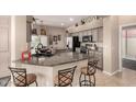 Eat-in kitchen features granite countertops, stainless steel appliances, breakfast bar, and plenty of cabinet space at 14124 W Bent Tree S Cir, Litchfield Park, AZ 85340