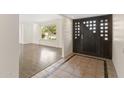 Inviting foyer with decorative tile flooring and a view into the light-filled living room with hardwood floors at 143 E Winter Dr, Phoenix, AZ 85020