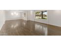 Spacious living room featuring gleaming hardwood floors, recessed lighting, and large windows for natural light at 143 E Winter Dr, Phoenix, AZ 85020