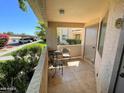 Private outdoor seating area on a covered balcony with tile flooring and storage at 145 N 74Th St # 125, Mesa, AZ 85207