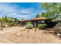 Attractive home featuring xeriscape landscaping, a walkway to the entrance, and solar panels at 1814 W Thomas Rd, Phoenix, AZ 85015