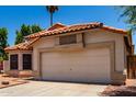 Charming single-story home with desert landscaping, tile roof, and a two-car garage at 18899 N 77Th Ave, Glendale, AZ 85308