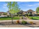 Landscaped front yard with synthetic grass and vibrant desert plants at 2094 E Aris Dr, Gilbert, AZ 85298