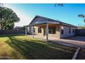 Spacious backyard featuring a covered patio, green lawn, and mature landscaping for outdoor enjoyment at 2281 E Saratoga St, Gilbert, AZ 85296