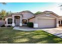 Charming single-Gathering home with a well-manicured lawn, mature landscaping, and a two-car garage at 2281 E Saratoga St, Gilbert, AZ 85296