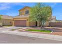 Beautiful two-story home with a brown garage door, desert landscaping, and a blue sky background at 2519 W Burgess Ln, Phoenix, AZ 85041