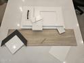 Selection of finish materials including cabinet, tile, flooring, and paint samples at 2559 E Virginia Cir, Mesa, AZ 85213