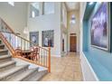 Elegant foyer with high ceilings, decorative wrought iron, and tile flooring leading to the dining area at 26703 N 90Th Dr, Peoria, AZ 85383
