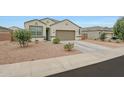 Single-story home featuring a two-car garage and a desert landscape at 30777 W Whitton Ave, Buckeye, AZ 85396
