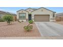 Inviting single-story home with a two-car garage and desert landscaping in front at 30777 W Whitton Ave, Buckeye, AZ 85396