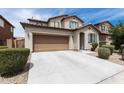 A bright shot of this house shows its large driveway, its two car garage, and trimmed green foliage at 322 N 78Th Pl, Mesa, AZ 85207