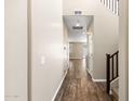 Inviting hallway with wood flooring leading to various rooms and staircase with dark trim at 322 N 78Th Pl, Mesa, AZ 85207