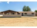 Charming single-story home featuring a neutral color palette and a spacious front yard at 3719 W Griswold Rd, Phoenix, AZ 85051