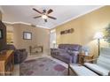 Bright living room with a ceiling fan, plush seating, and tile flooring with a decorative area rug at 3830 E Lakewood Pkwy # 1057, Phoenix, AZ 85048