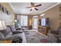 Inviting living room boasts plush seating, ceiling fan, and ample natural light creating a comfortable atmosphere at 3830 E Lakewood Pkwy # 1057, Phoenix, AZ 85048