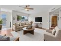 Bright living room with a ceiling fan, large window, and modern decor for a comfortable, inviting space at 4102 W Golden Ln, Phoenix, AZ 85051