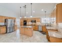 Bright, updated kitchen with stainless steel appliances, granite countertops, and center island at 4353 W Walton Way, Chandler, AZ 85226