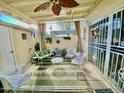 Cozy covered patio with a ceiling fan, stylish white furniture, and a vibrant green rug at 4599 N 17Th Ave, Phoenix, AZ 85015