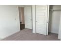 Bright bedroom with closet space, neutral carpeting, and an attached room at 48402 N Duran Way, Gold Canyon, AZ 85118