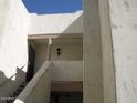 A condo exterior featuring stairs leading to upper units with stucco walls and exterior lighting at 5035 N 17Th Ave # 205, Phoenix, AZ 85015