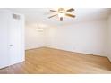 Bright, open living room with beautiful wood floors, ceiling fan and chandelier at 5035 N 17Th Ave # 205, Phoenix, AZ 85015